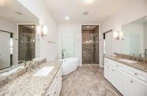 a spacious bathroom with a granite countertop sink and a mirror