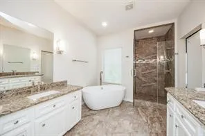 a spacious bathroom with a granite countertop sink a mirror and a shower