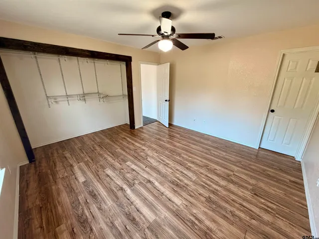 a view of a room with wooden floor