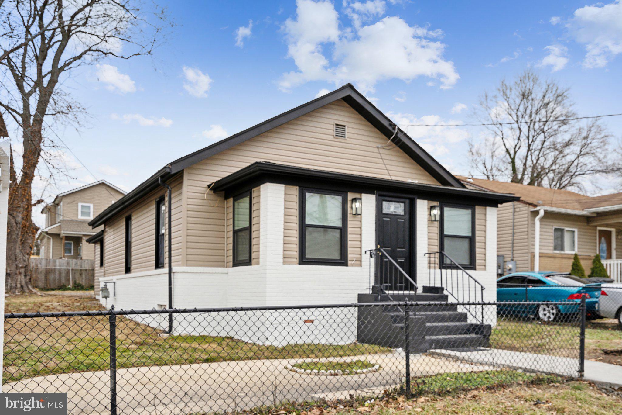 a front view of a house with iron fence