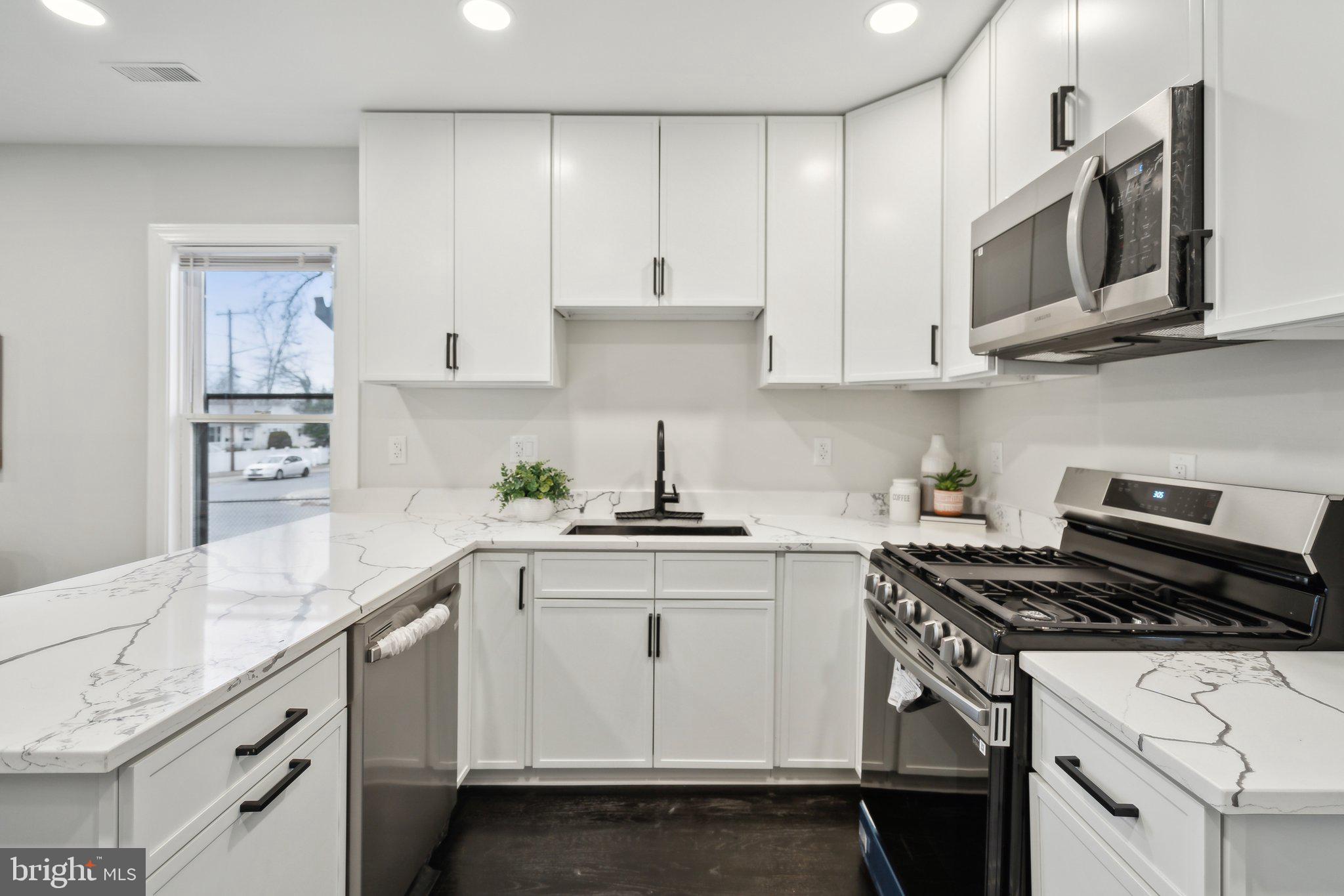 421 Dateleaf Avenue Capitol Heights, MD 20743 - Photo 15 of 39 a kitchen with stainless steel appliances granite countertop a sink a stove and cabinets
