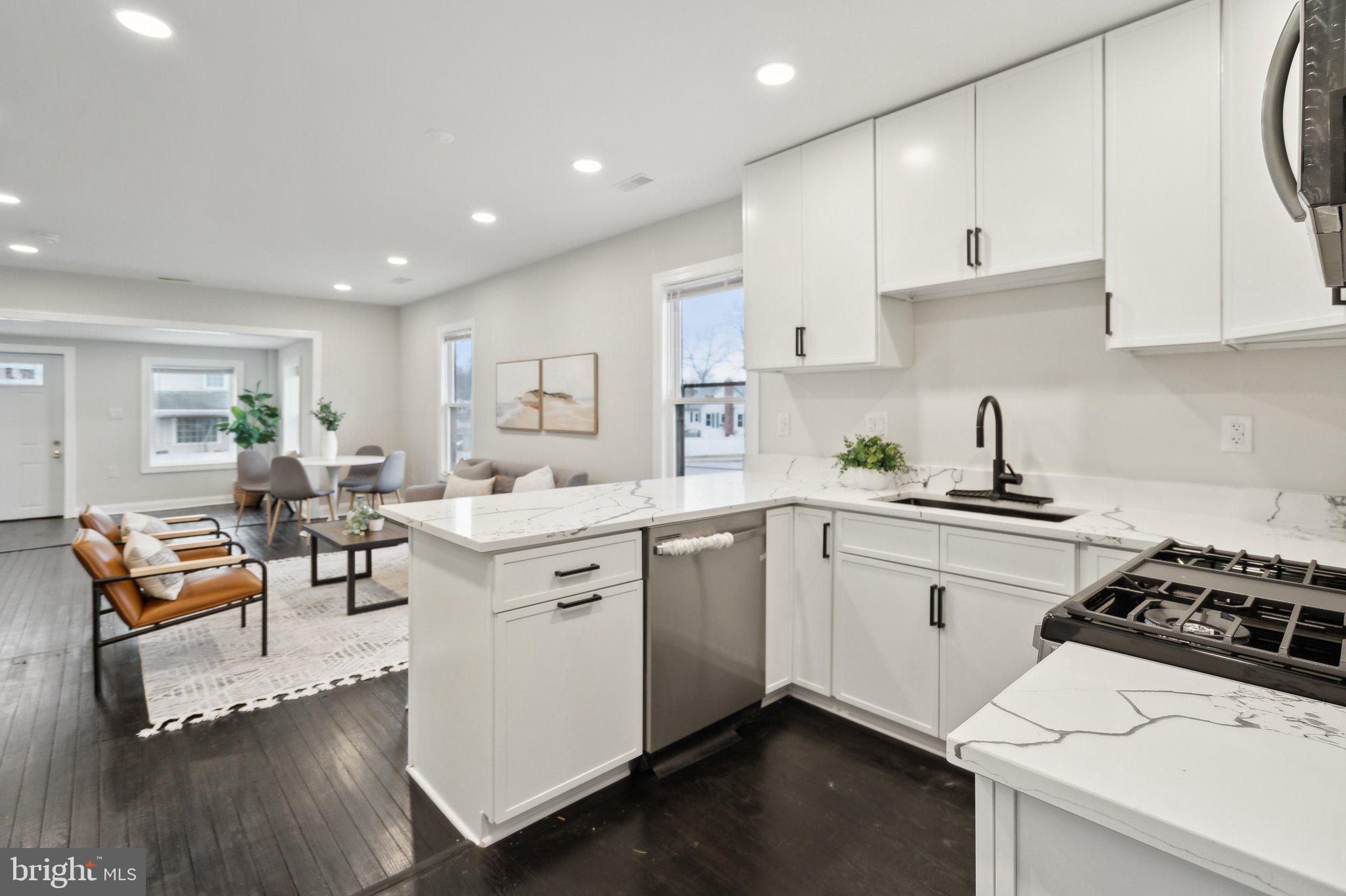 421 Dateleaf Avenue Capitol Heights, MD 20743 - Photo 16 of 39 a kitchen with a sink cabinets and wooden floor