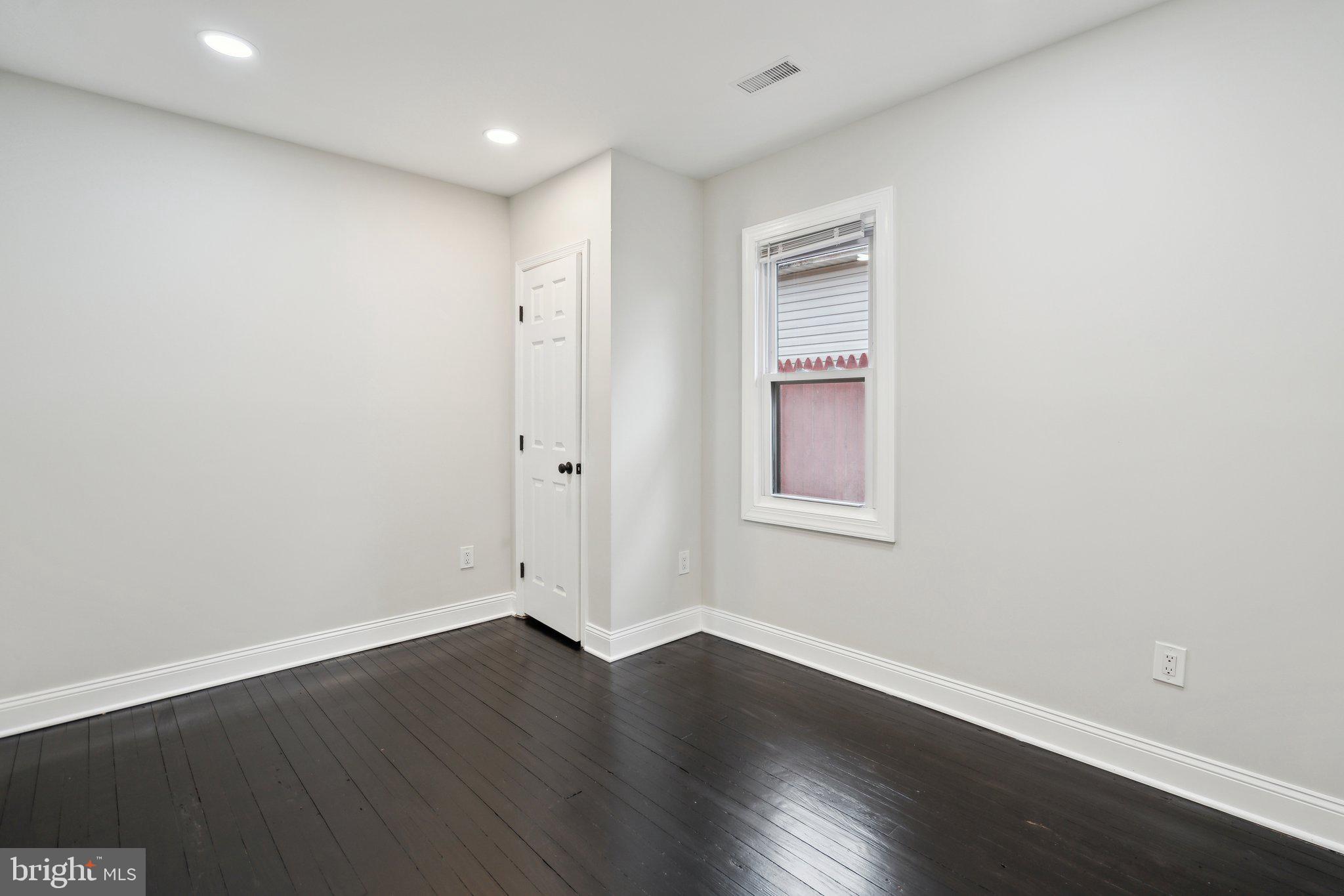 421 Dateleaf Avenue Capitol Heights, MD 20743 - Photo 26 of 39 a view of an empty room with wooden floor and a window