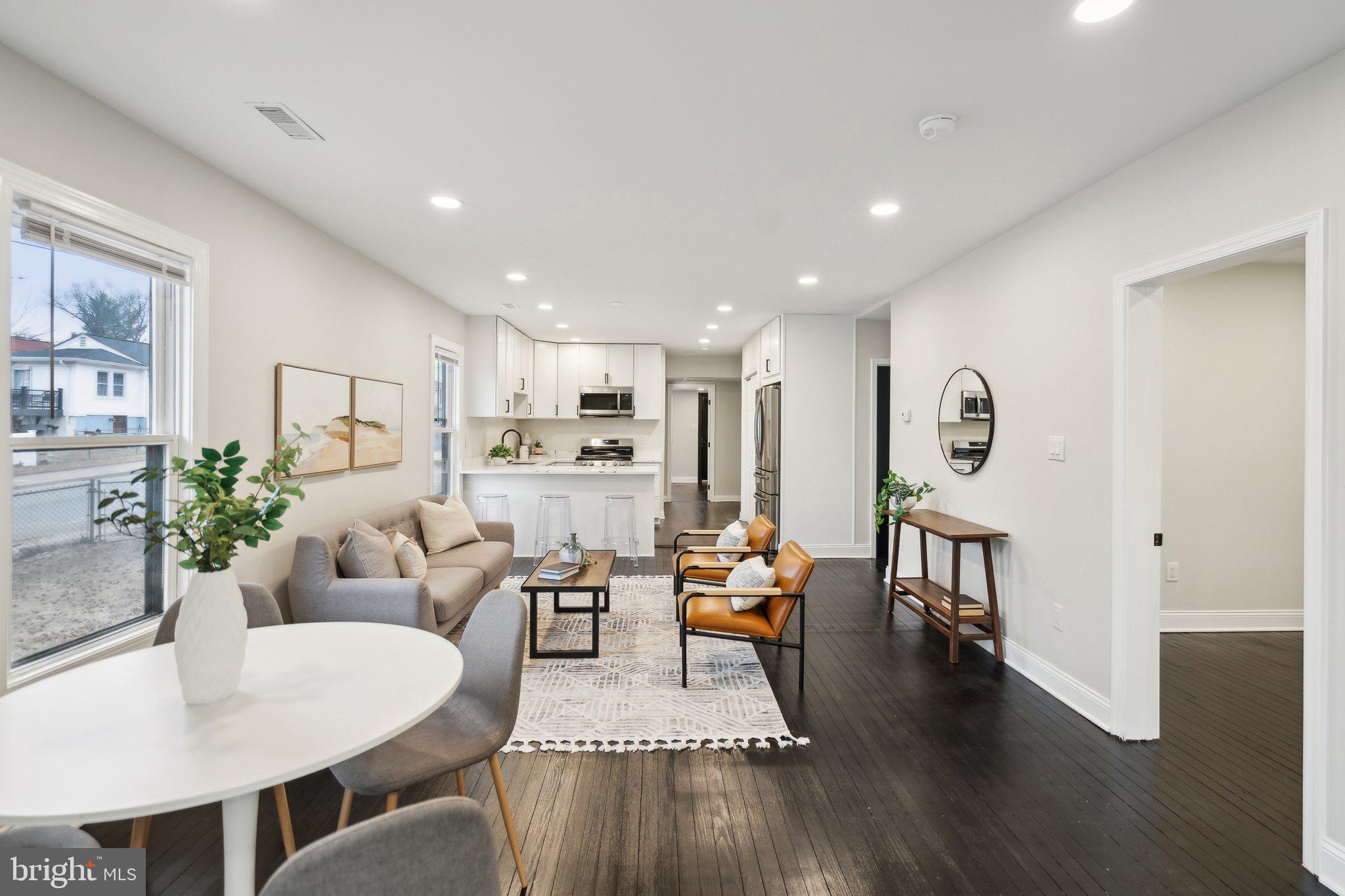 421 Dateleaf Avenue Capitol Heights, MD 20743 - Photo 6 of 39 a living room with furniture kitchen view and a wooden floor