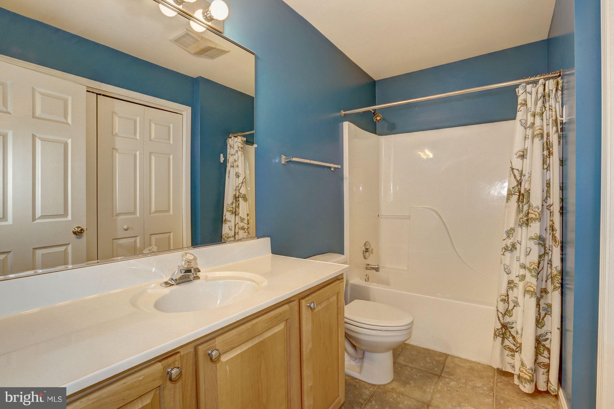 1407 Jasper Street Silver Spring, MD 20902 - Photo 13 of 21 a bathroom with a granite countertop sink toilet a shower and a mirror