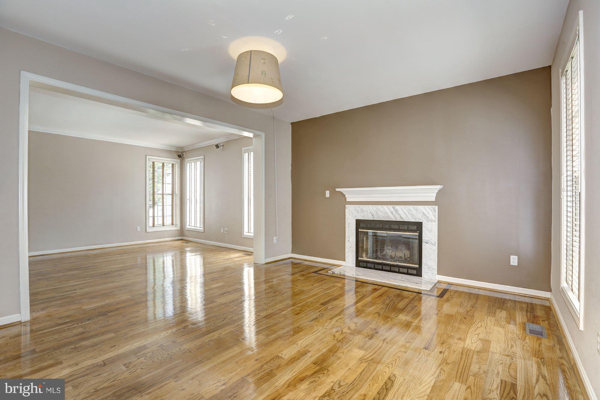 1407 Jasper Street Silver Spring, MD 20902 - Photo 5 of 21 an empty room with wooden floor fireplace and window