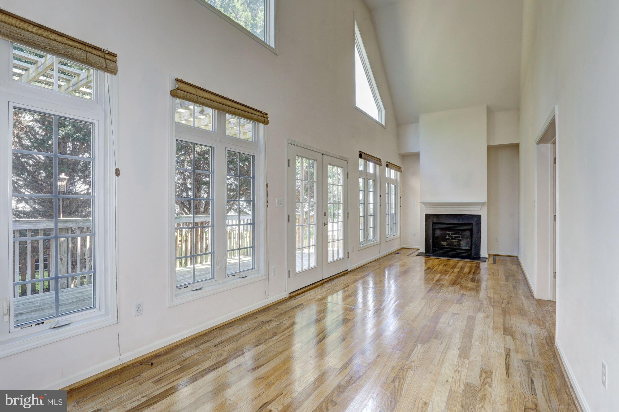 1407 Jasper Street Silver Spring, MD 20902 - Photo 6 of 21 a view of an empty room with wooden floor and a window