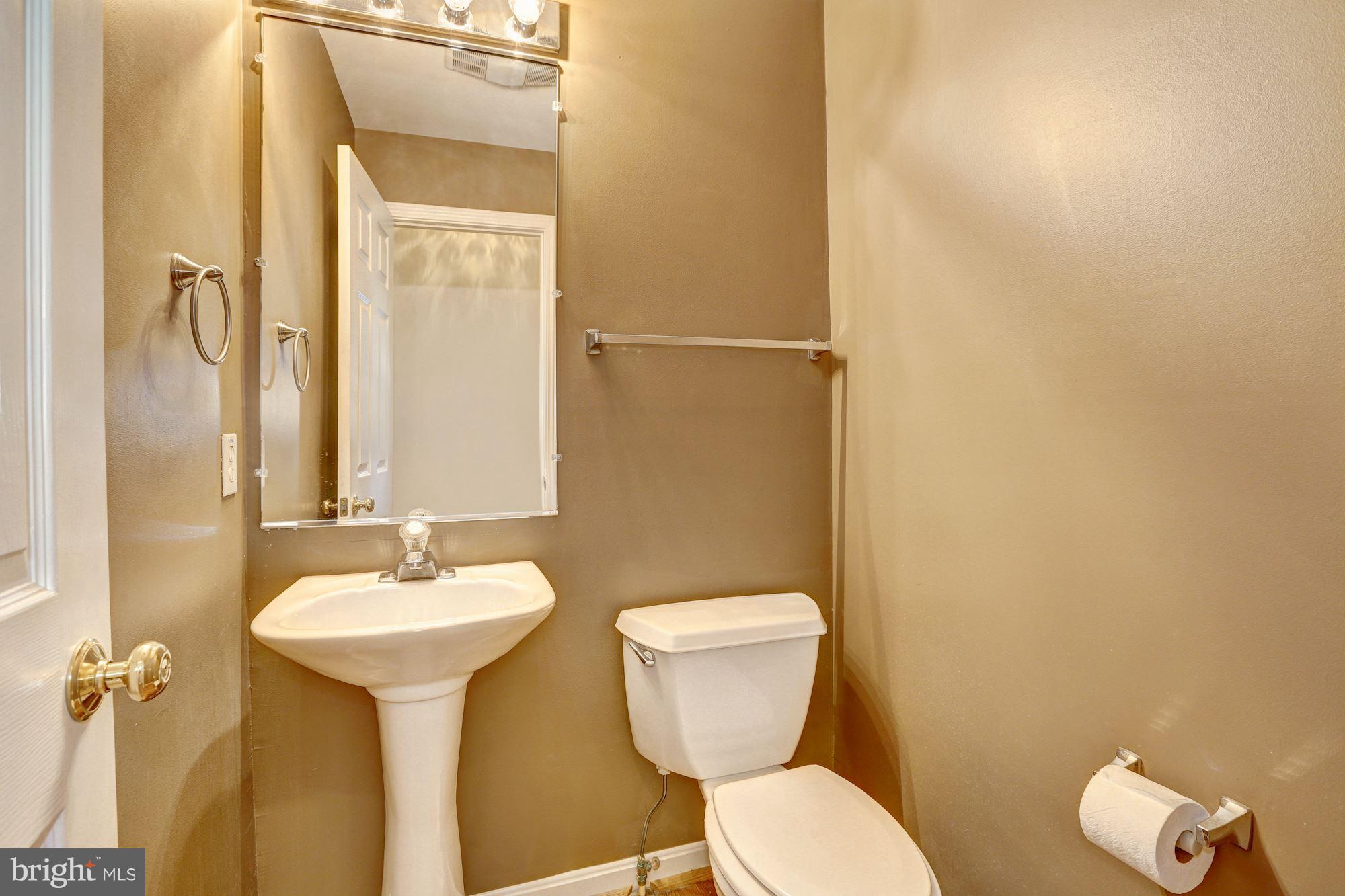 1407 Jasper Street Silver Spring, MD 20902 - Photo 7 of 21 a bathroom with a toilet sink and mirror
