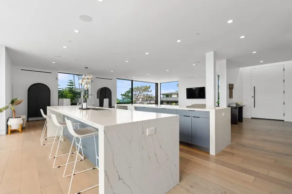a large kitchen with stainless steel appliances kitchen island a large counter top and a view of living room
