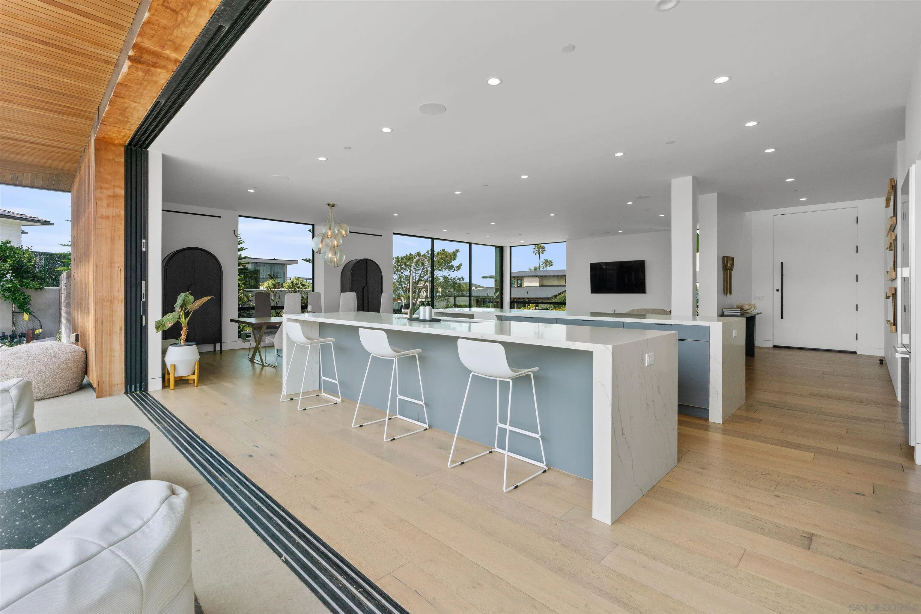 223 Ocean Street Solana Beach, CA 92075 - Photo 15 of 47 a large kitchen with stainless steel appliances kitchen island a large counter top and a view of living room