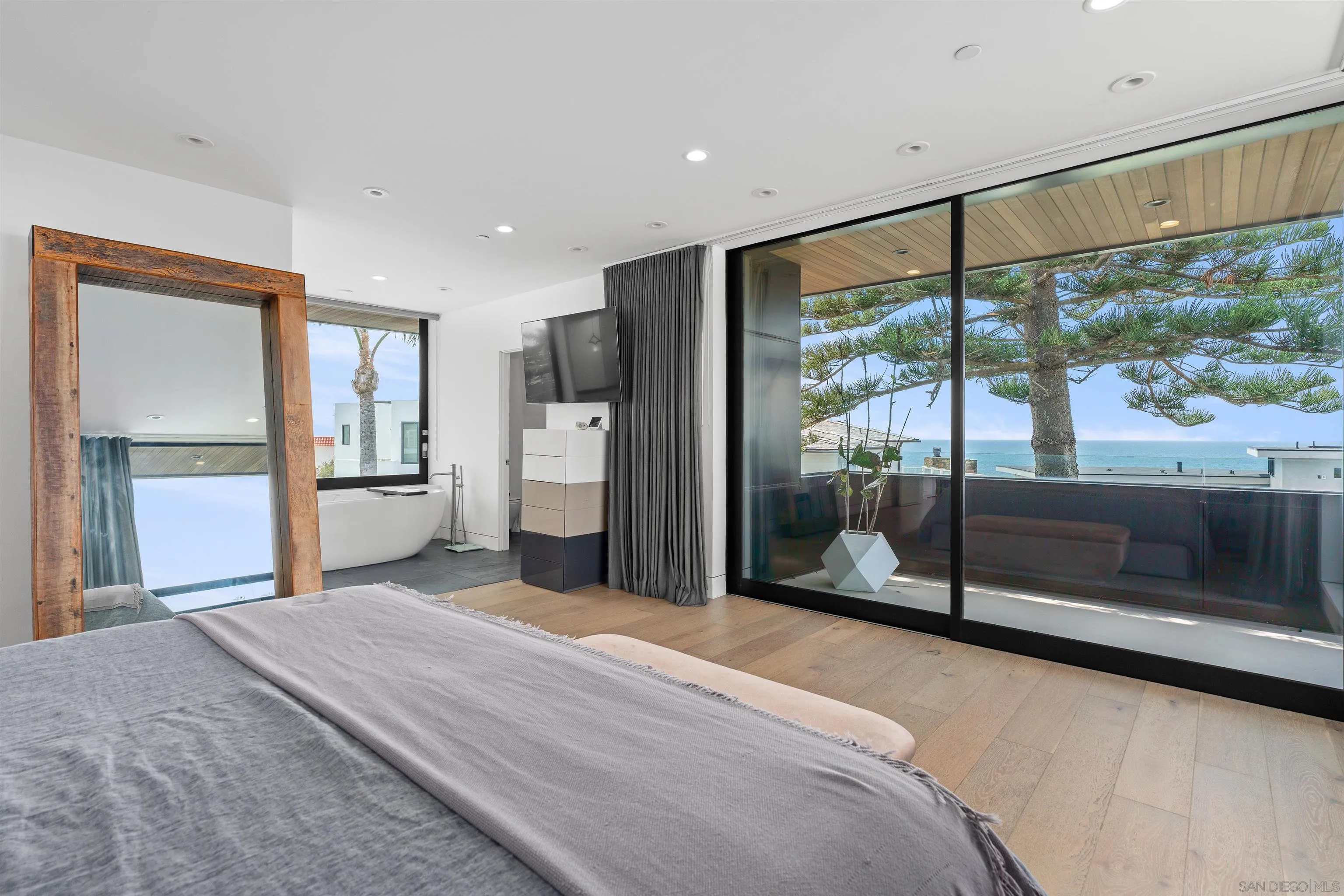 223 Ocean Street Solana Beach, CA 92075 - Photo 23 of 47 a bedroom with a bed and large glass window