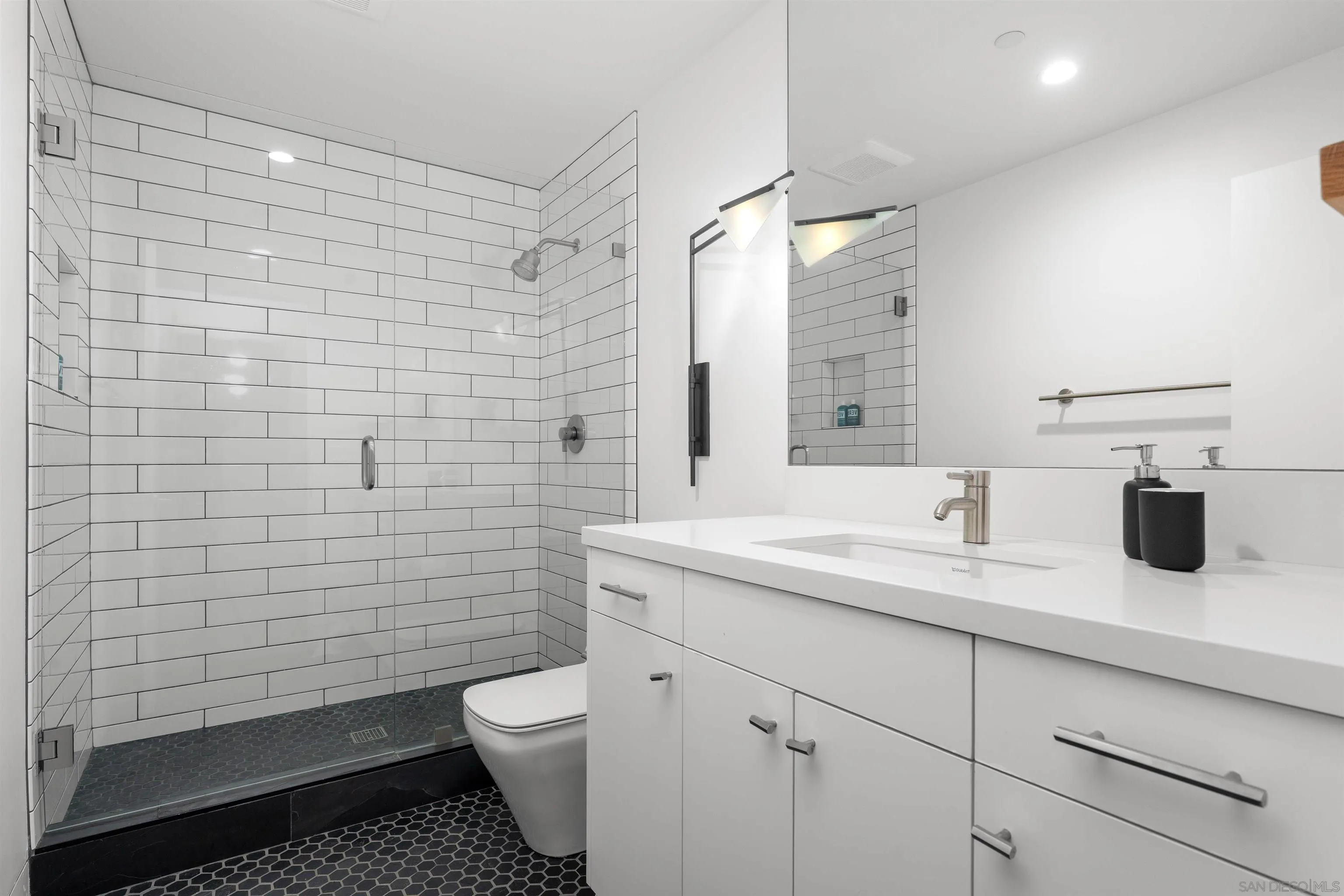 223 Ocean Street Solana Beach, CA 92075 - Photo 29 of 47 a bathroom with a granite countertop toilet sink and mirror