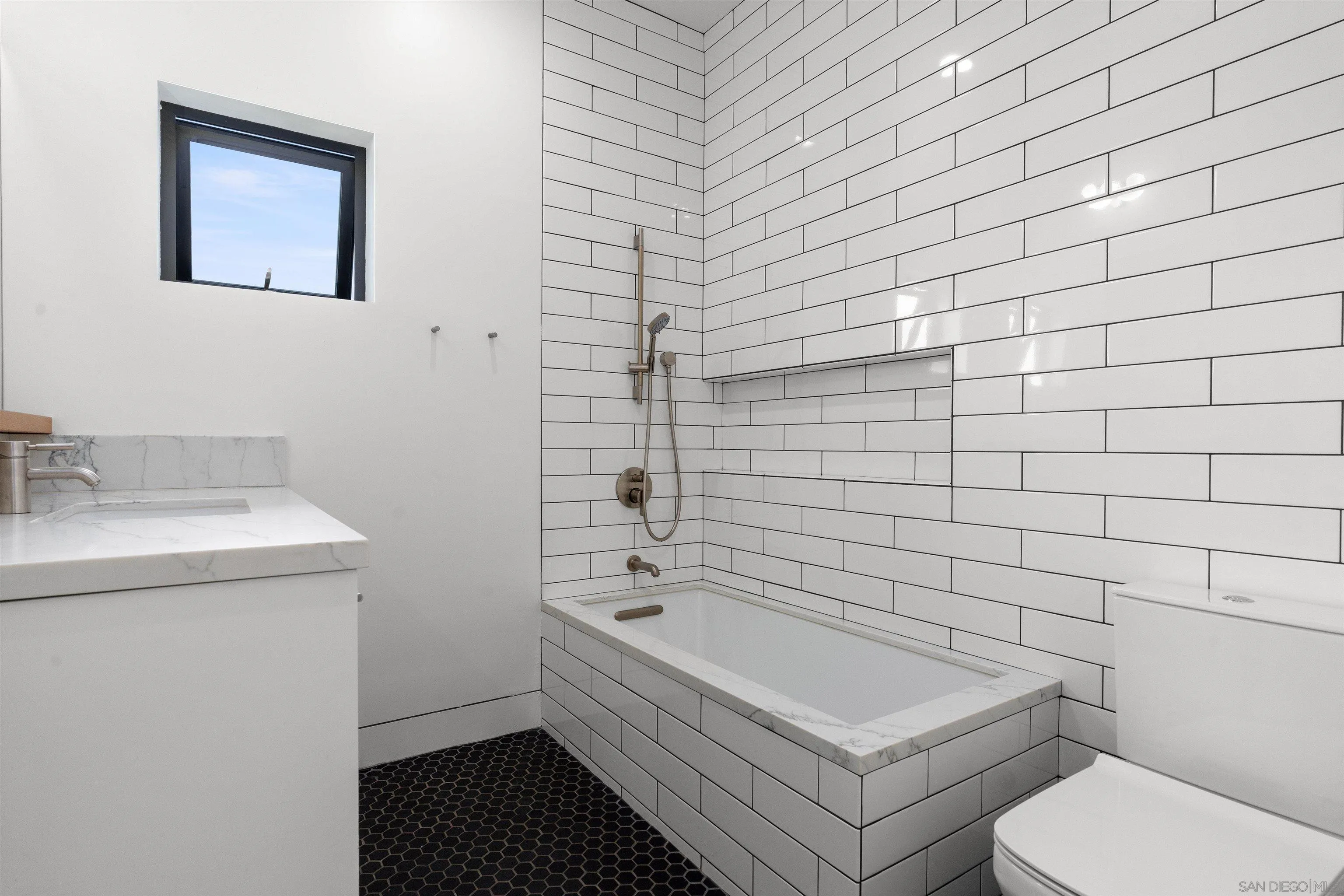 223 Ocean Street Solana Beach, CA 92075 - Photo 30 of 47 a bathroom with a toilet a sink and mirror