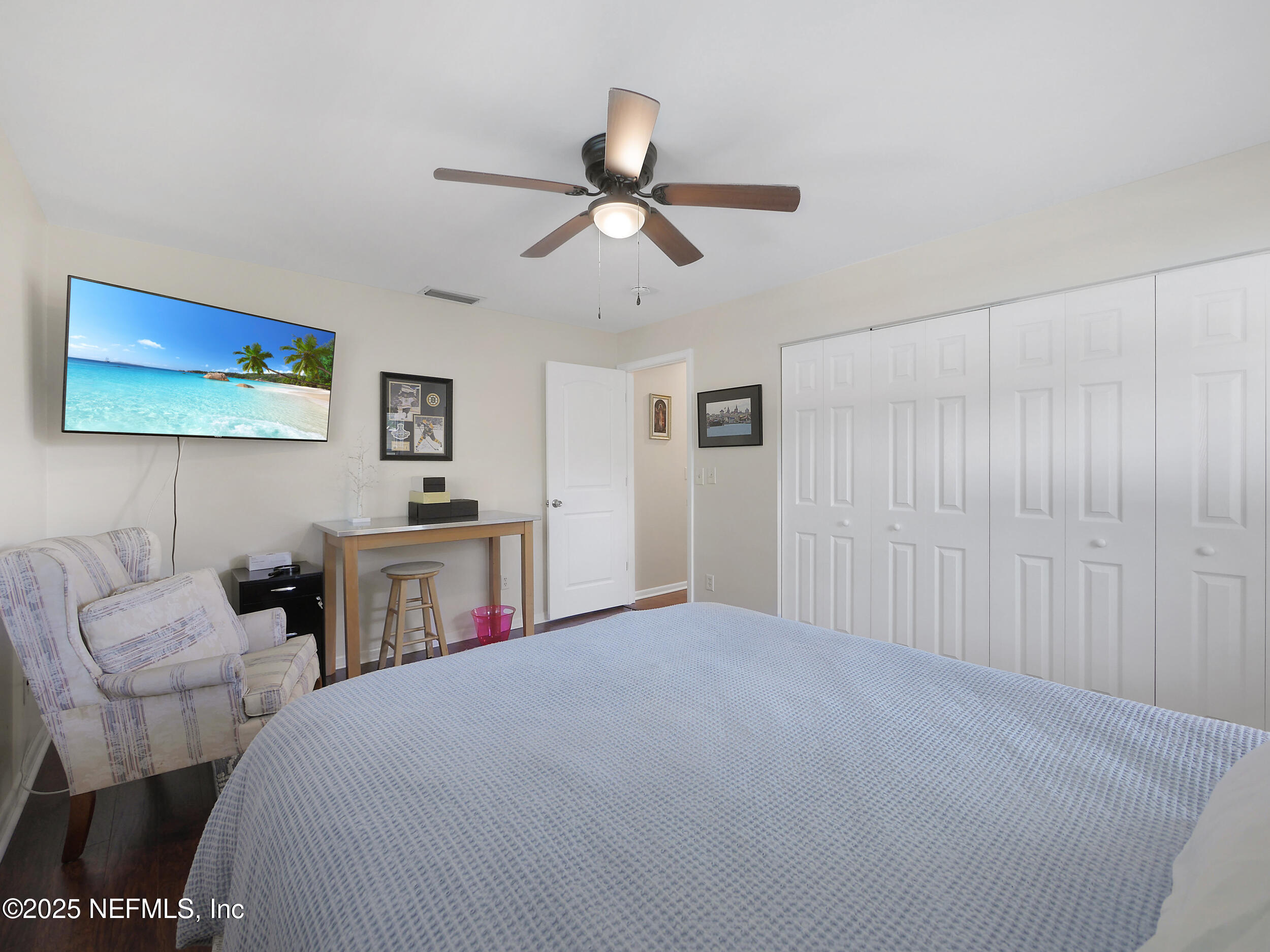 971 Viscaya Boulevard St. Augustine, FL 32086 - Photo 21 of 47 a bedroom with a bed and a chandelier