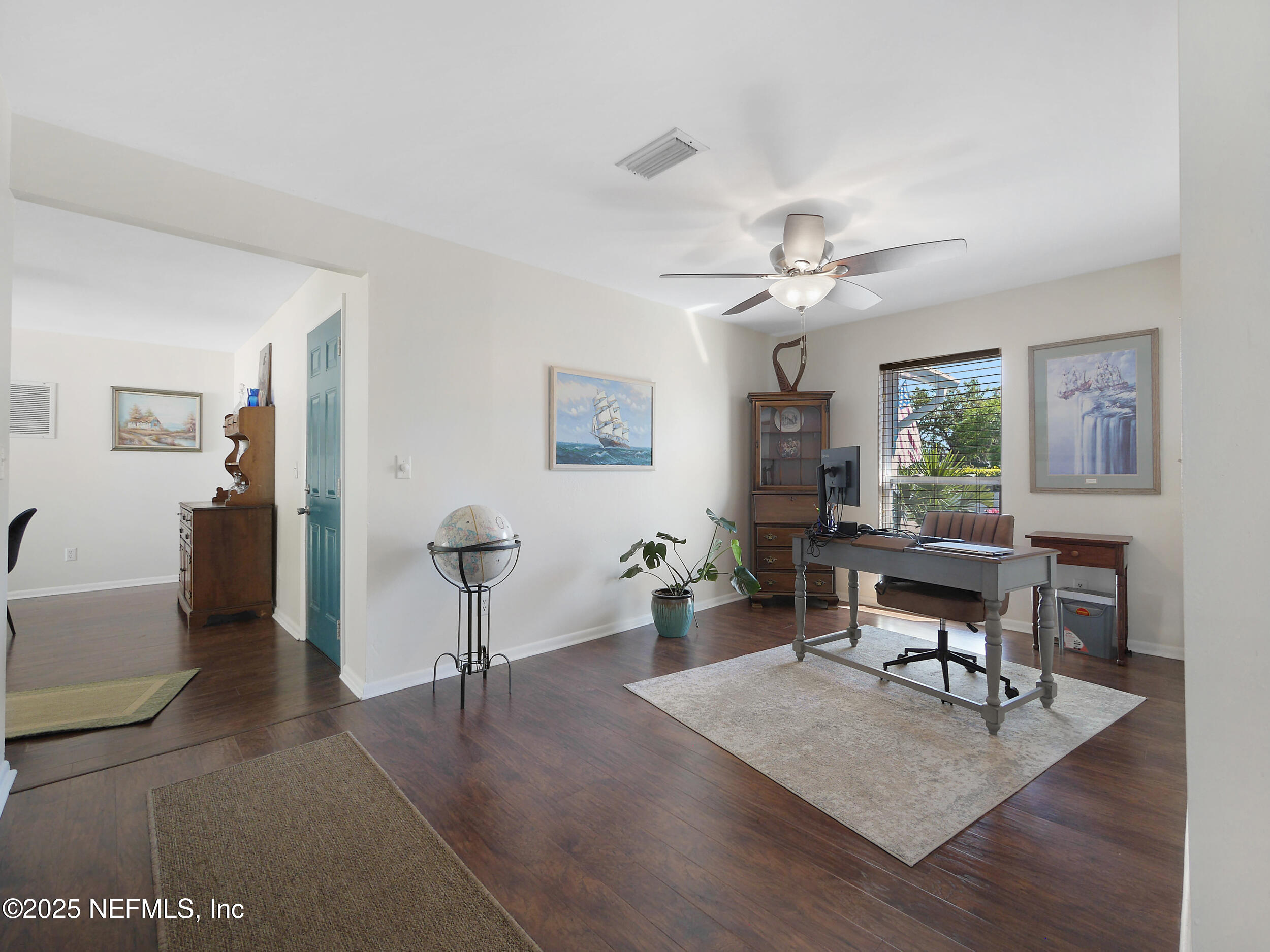 971 Viscaya Boulevard St. Augustine, FL 32086 - Photo 26 of 47 a living room with furniture a table and wooden floor