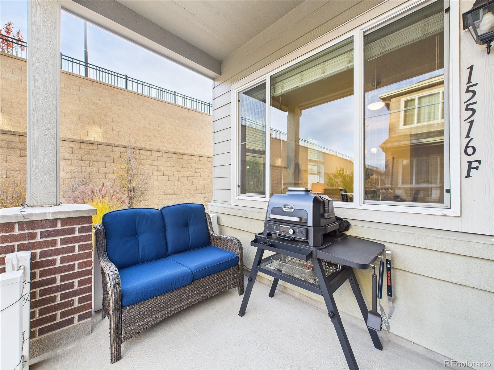 15516 West 64th Loop, Unit F Arvada, CO 80007 - Photo 12 of 23 a blue chair sitting in front of a window