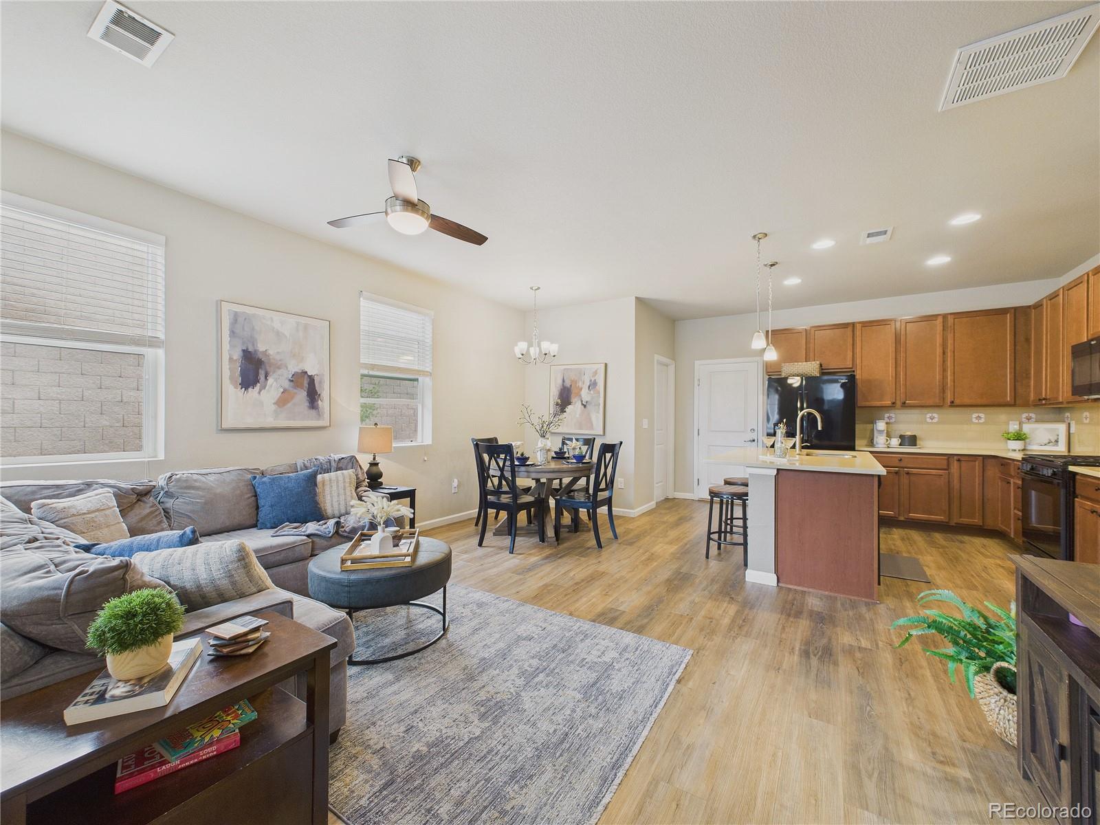 15516 West 64th Loop, Unit F Arvada, CO 80007 - Photo 13 of 23 a living room with lots of furniture and kitchen view