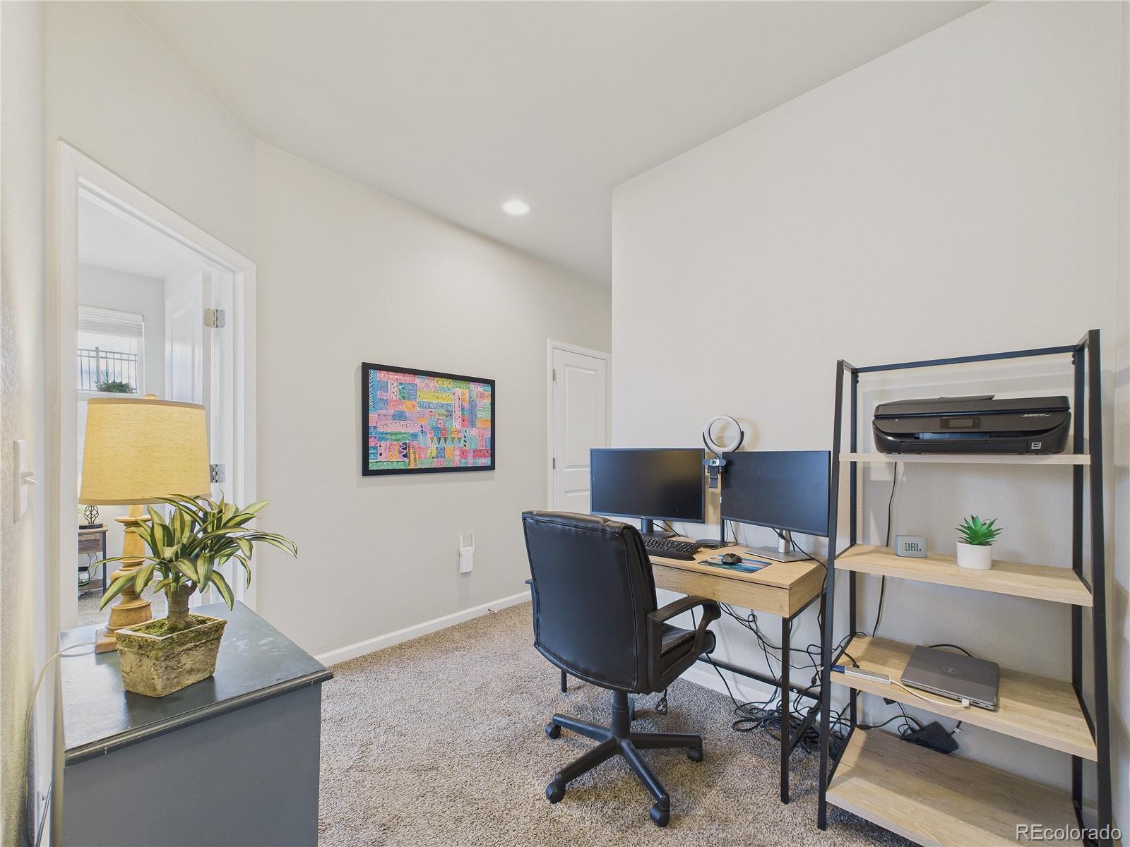 15516 West 64th Loop, Unit F Arvada, CO 80007 - Photo 18 of 23 a workspace with furniture and a potted plant