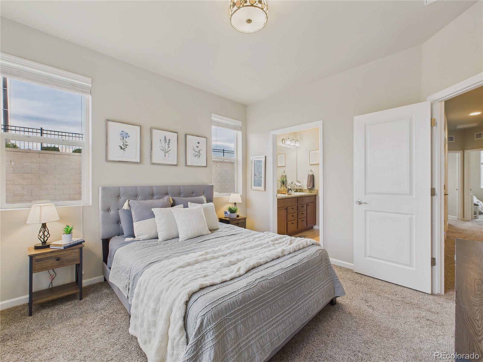 15516 West 64th Loop, Unit F Arvada, CO 80007 - Photo 3 of 23 a bedroom with a bed and a view of kitchen