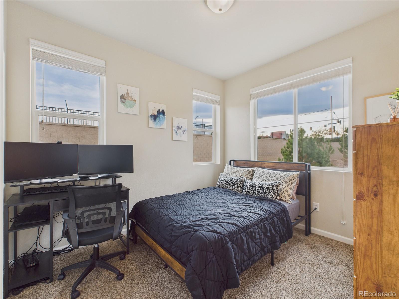 15516 West 64th Loop, Unit F Arvada, CO 80007 - Photo 7 of 23 a bedroom with a bed and a window