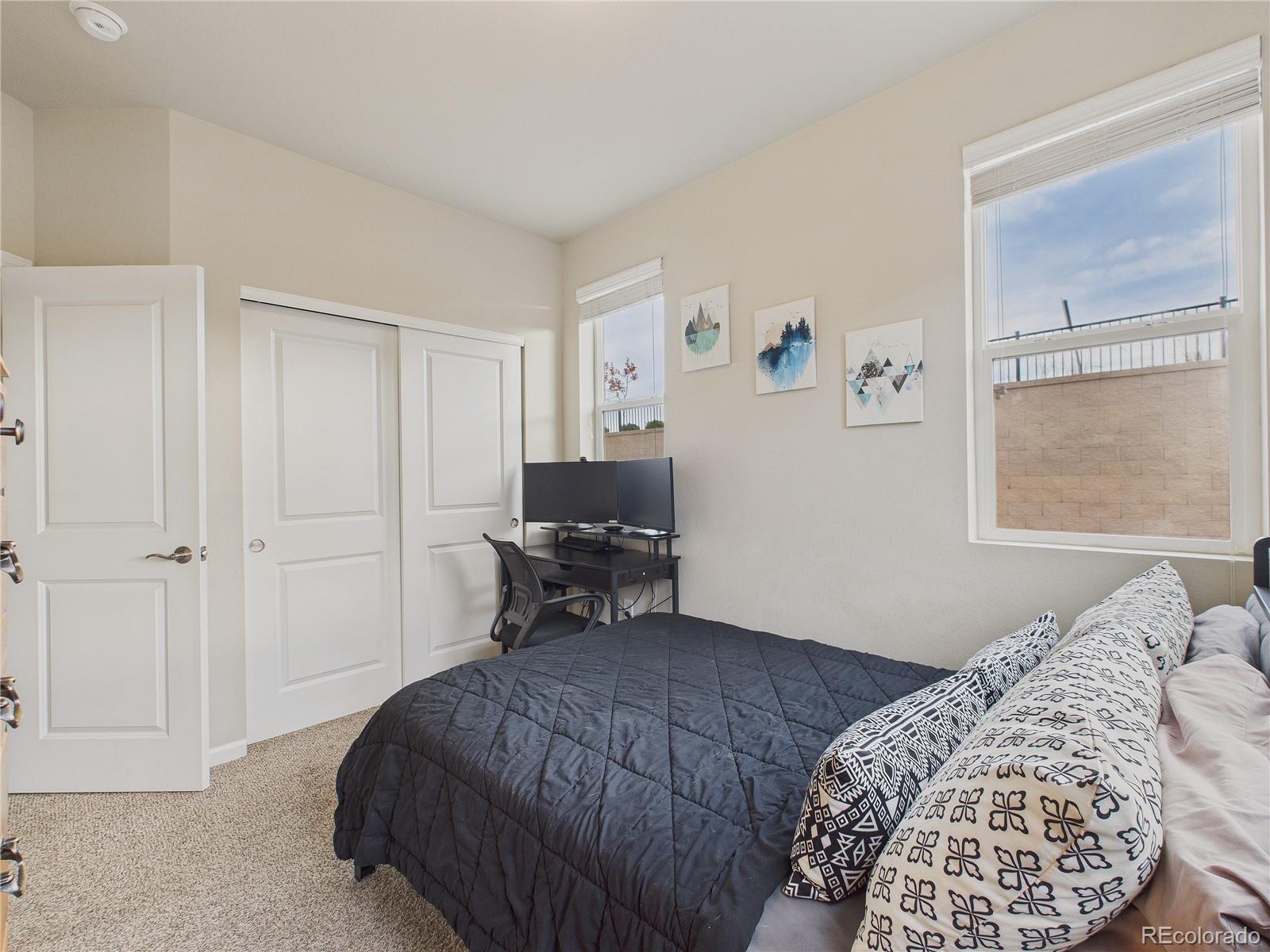 15516 West 64th Loop, Unit F Arvada, CO 80007 - Photo 8 of 23 a bedroom with a bed and a window