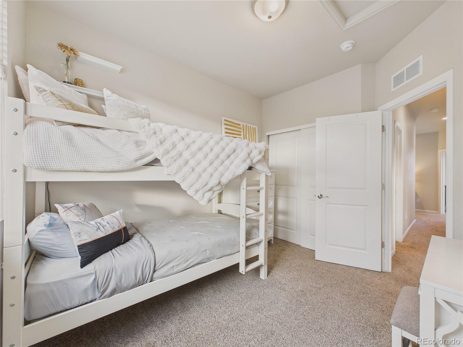 15516 West 64th Loop, Unit F Arvada, CO 80007 - Photo 10 of 23 a bedroom with a bed and a window