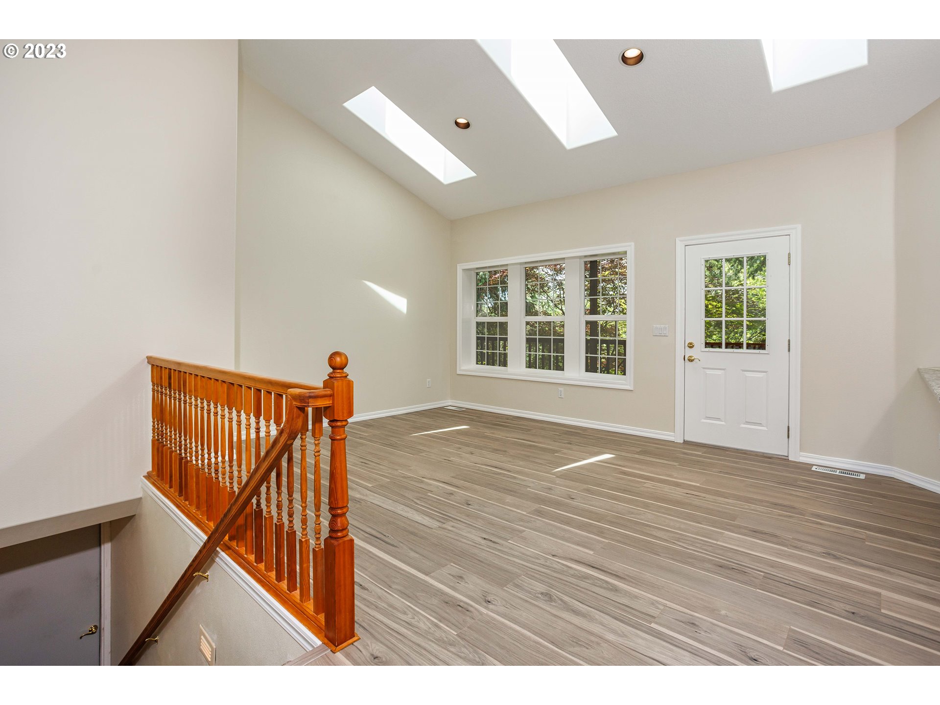 280 South 15th Court Ridgefield, WA 98642 - Photo 12 of 44 a view of an empty room with wooden floor and a window