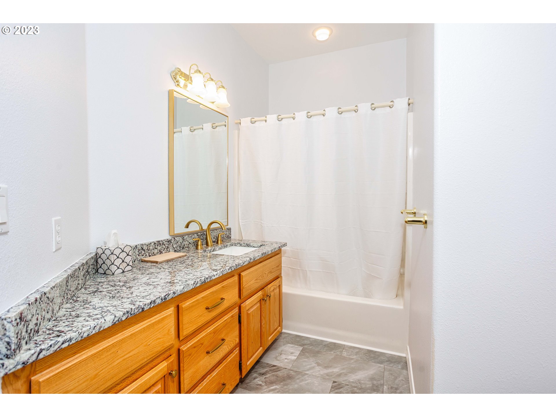 280 South 15th Court Ridgefield, WA 98642 - Photo 22 of 44 a bathroom with a granite countertop sink and a mirror