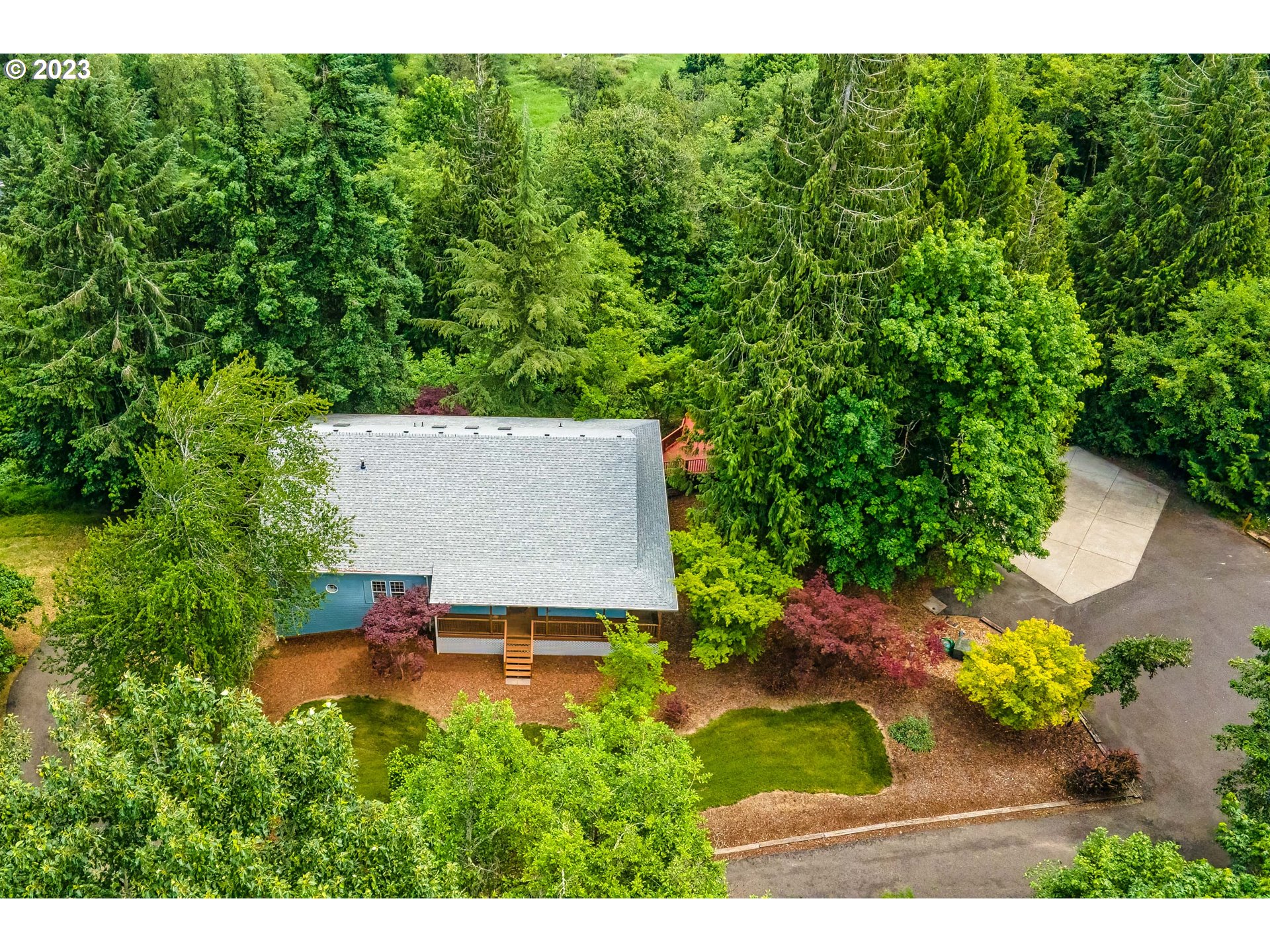 280 South 15th Court Ridgefield, WA 98642 - Photo 38 of 44 a view of a backyard with a garden and trees