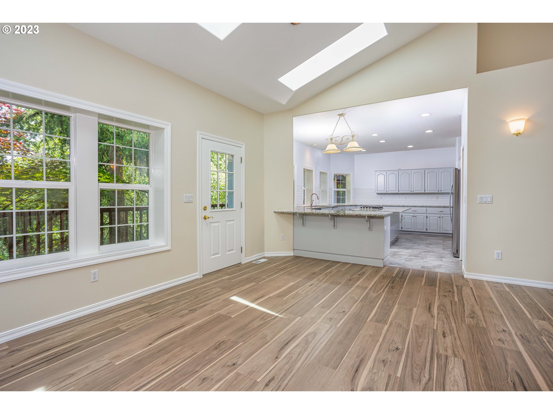 280 South 15th Court Ridgefield, WA 98642 - Photo 8 of 44 a view of a kitchen with wooden floor and a kitchen