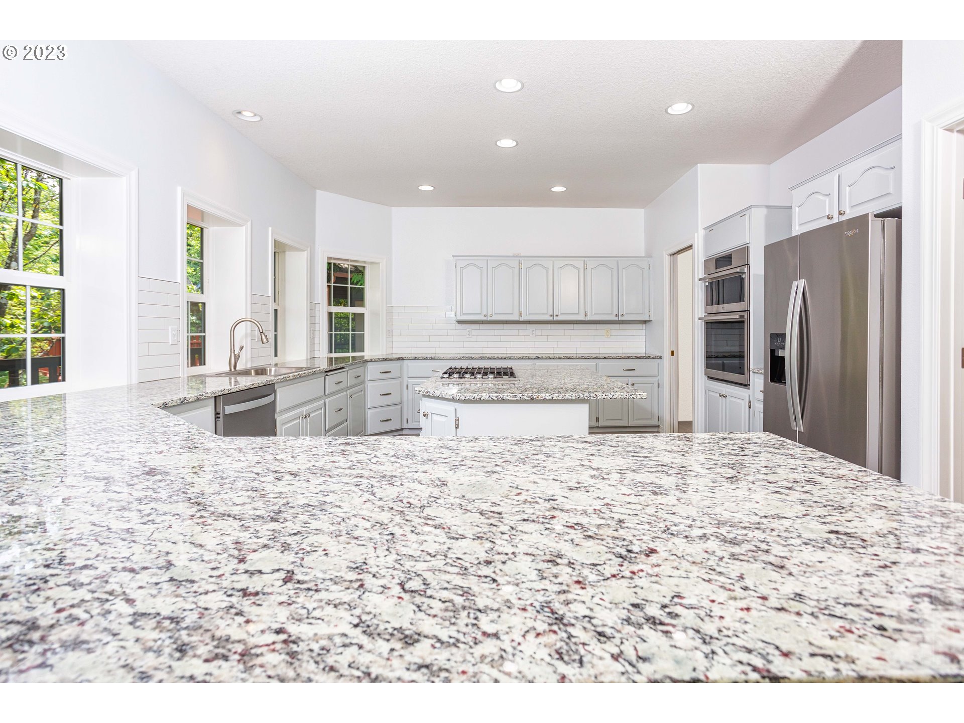 280 South 15th Court Ridgefield, WA 98642 - Photo 9 of 44 a large kitchen with kitchen island a sink stove and refrigerator