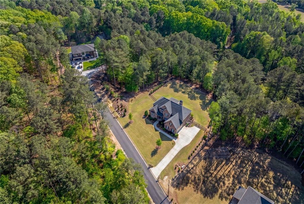 1559 Whitley Road Dacula, GA 30019 - Photo 33 of 34 an aerial view of a house with a yard and trees