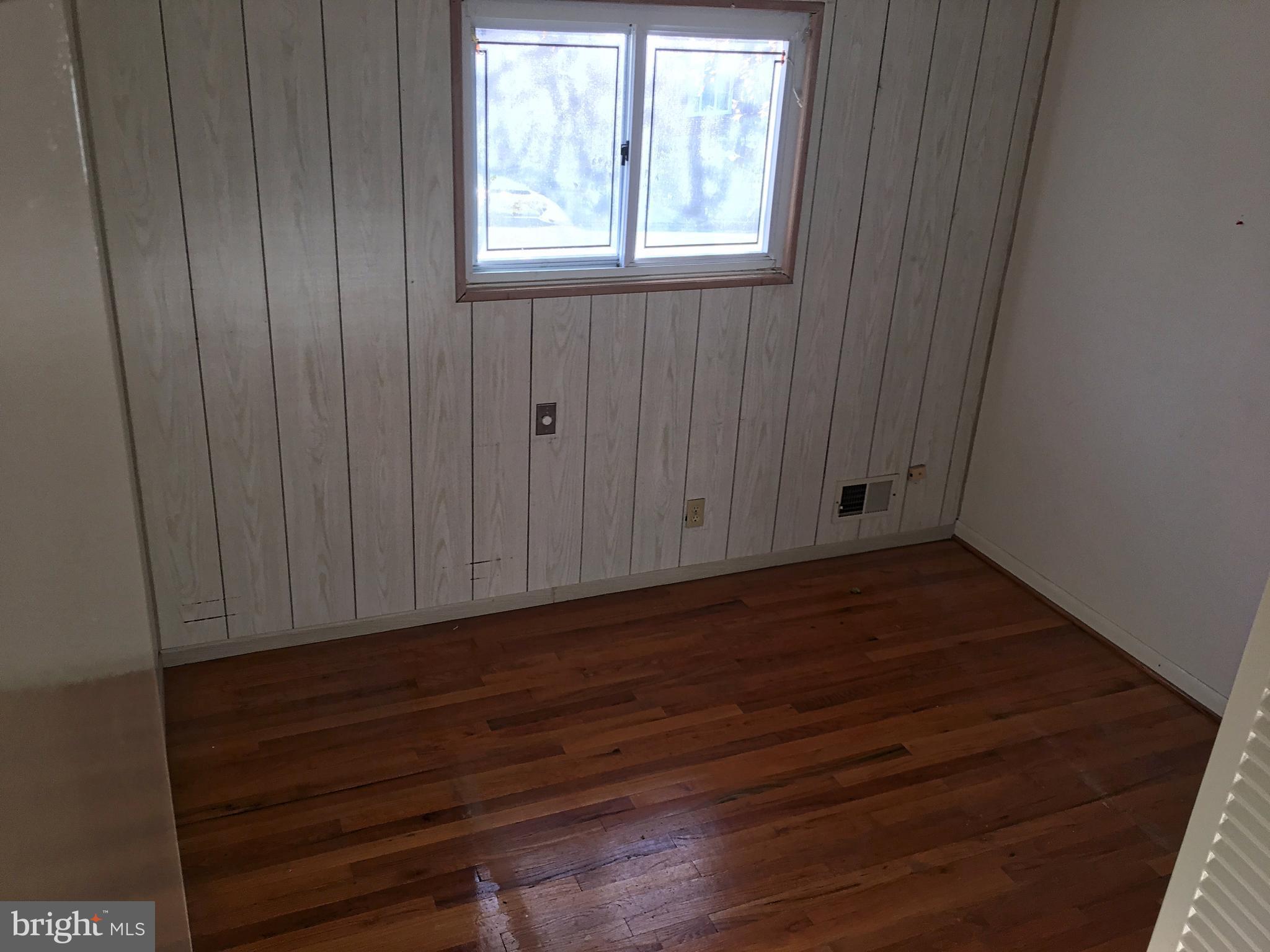 4710 Byron Road Baltimore, MD 21244 - Photo 11 of 24 a view of an empty room with wooden floor and a window