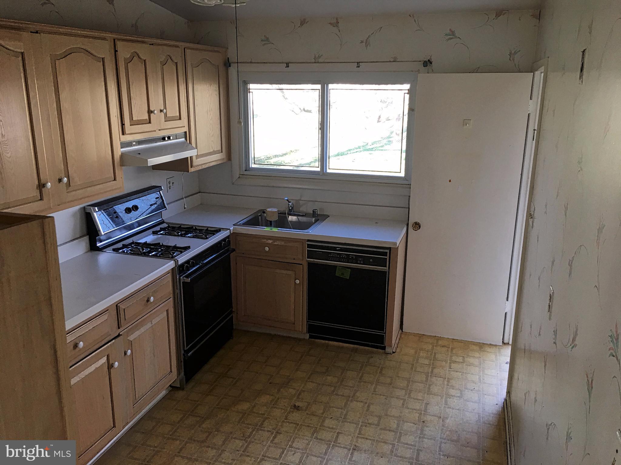 4710 Byron Road Baltimore, MD 21244 - Photo 7 of 24 a kitchen with a stove sink and window