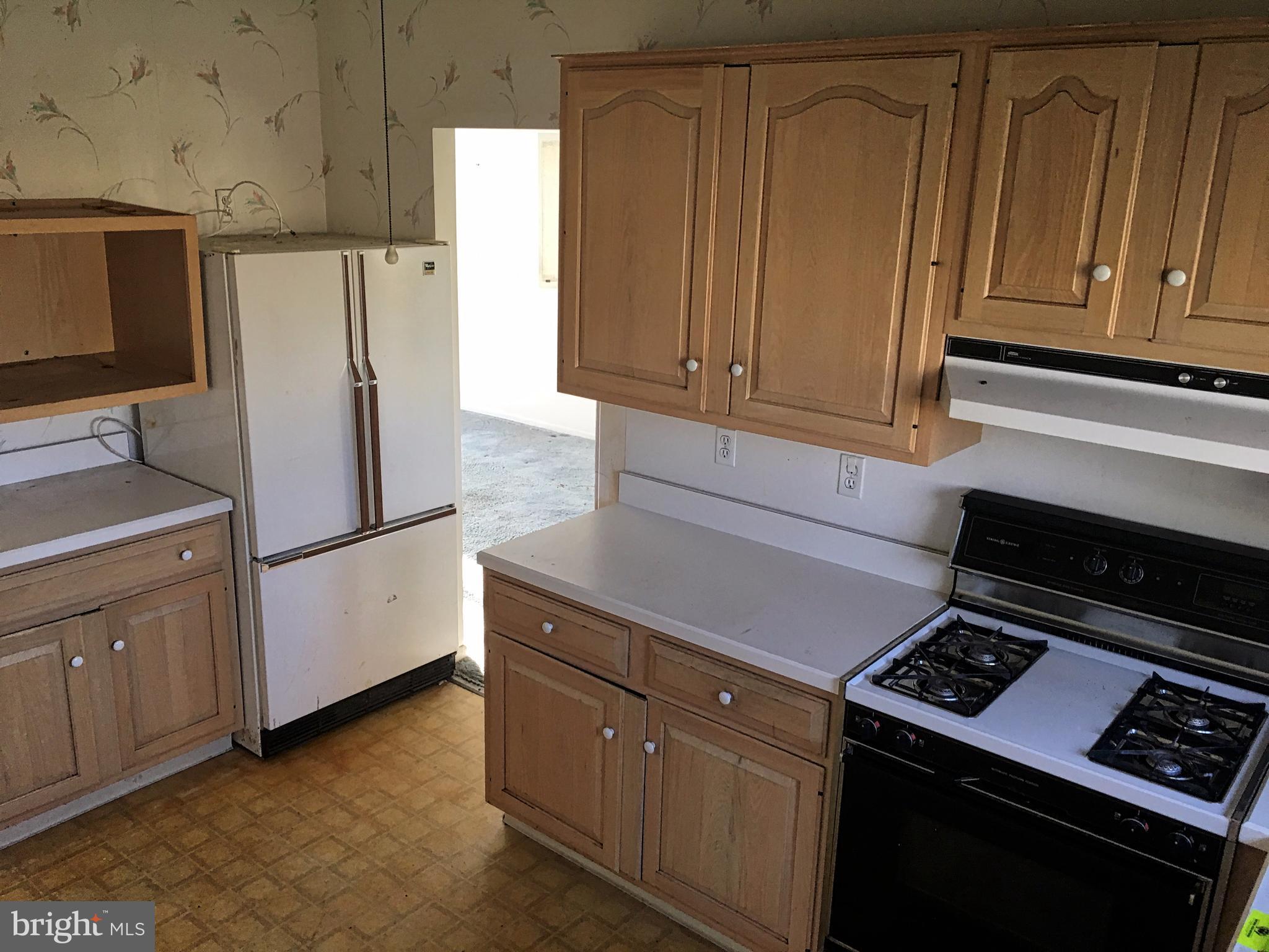 4710 Byron Road Baltimore, MD 21244 - Photo 8 of 24 a kitchen with cabinets and steel stainless steel appliances