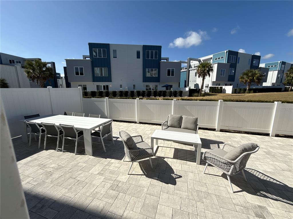 7740 Sandy Ridge Drive, Unit 120 Reunion, FL 34747 - Photo 26 of 36 a outdoor space with a large window and furniture