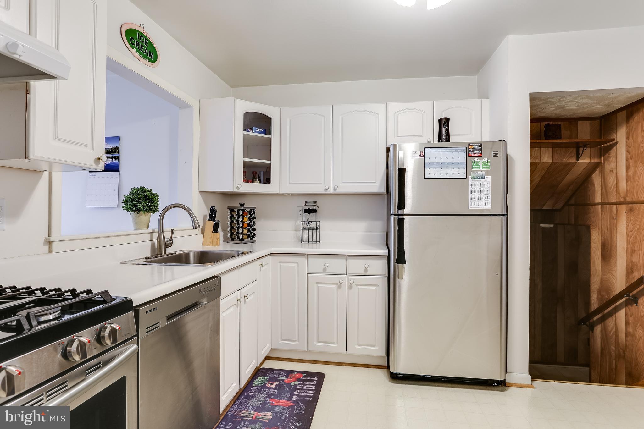 936 Vanderwood Road Baltimore, MD 21228 - Photo 11 of 27 a kitchen with appliances a refrigerator and a sink