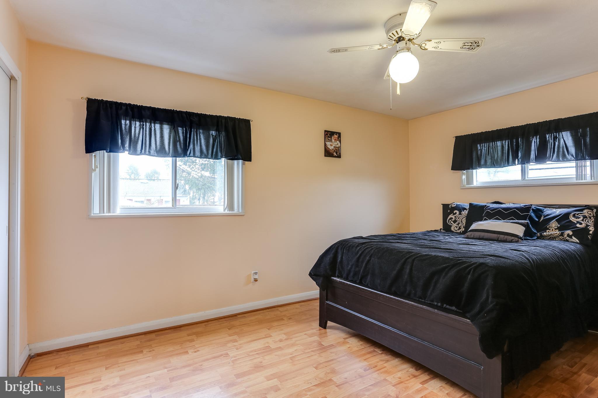 936 Vanderwood Road Baltimore, MD 21228 - Photo 13 of 27 a spacious bedroom with a bed and a window
