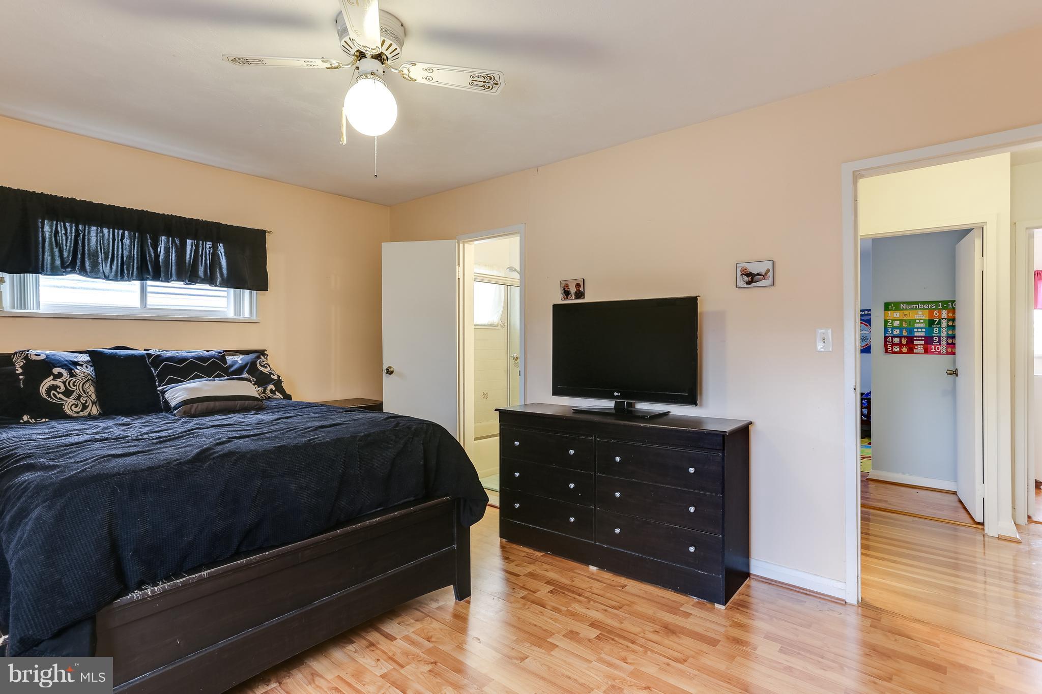 936 Vanderwood Road Baltimore, MD 21228 - Photo 14 of 27 a bedroom with a bed and a flat screen tv