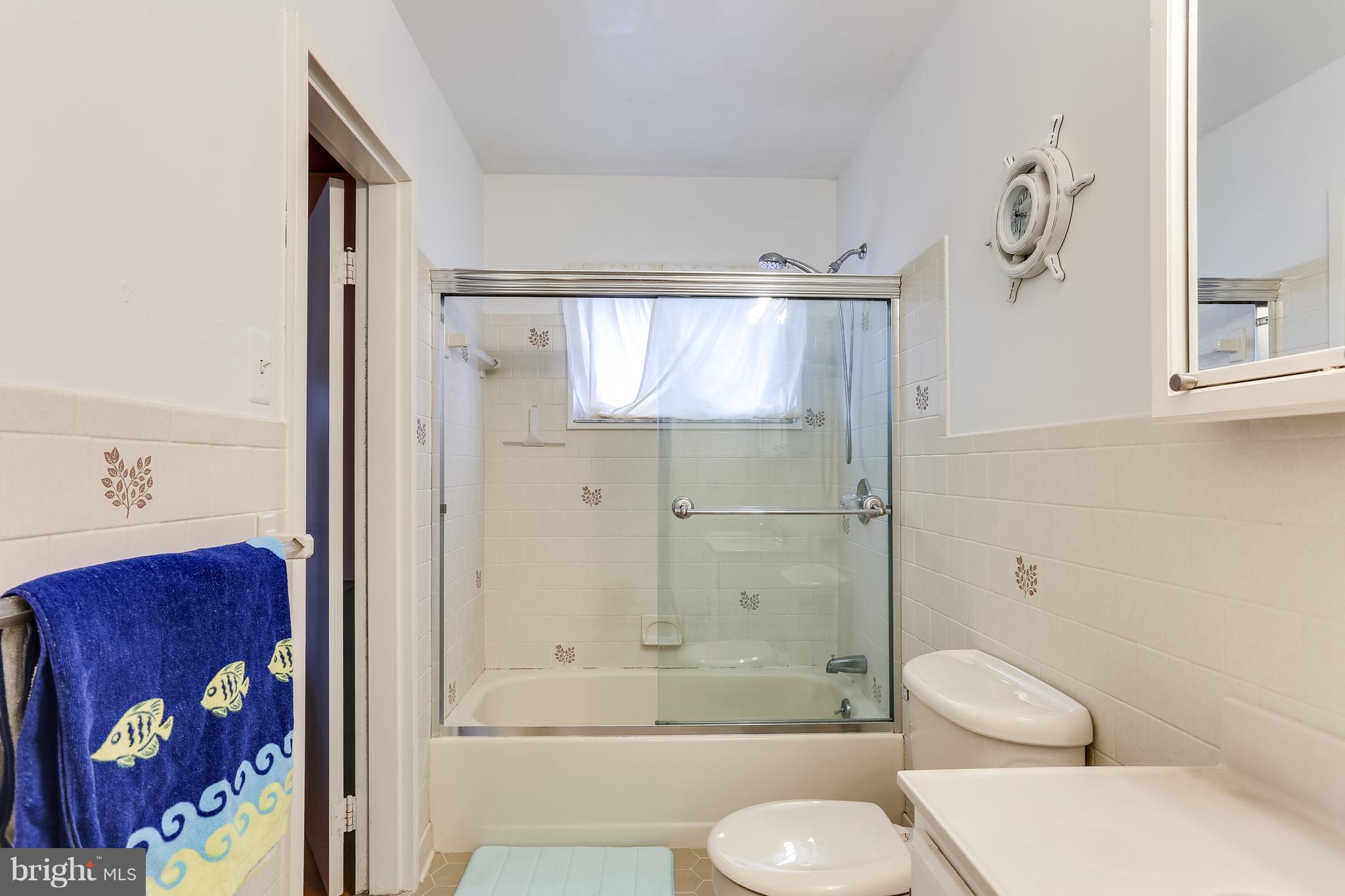 936 Vanderwood Road Baltimore, MD 21228 - Photo 16 of 27 a bathroom with a toilet and a shower