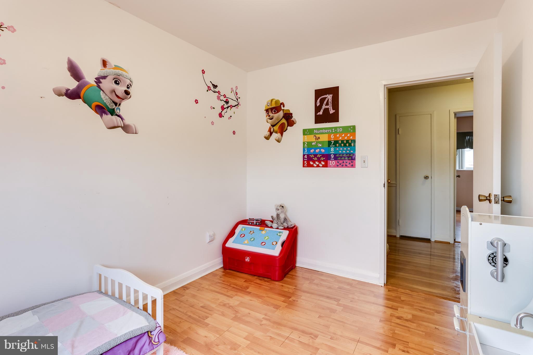 936 Vanderwood Road Baltimore, MD 21228 - Photo 20 of 27 a bedroom with a bed and a couch
