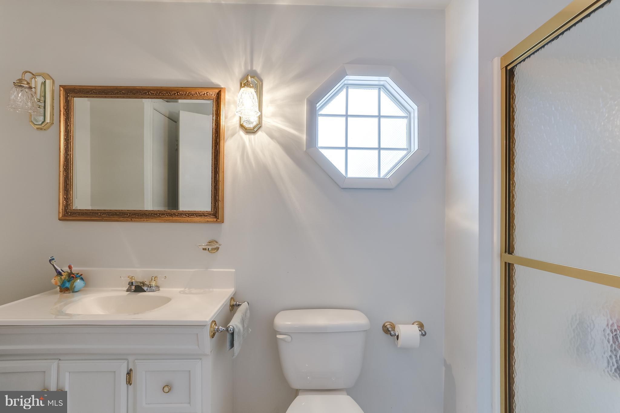 936 Vanderwood Road Baltimore, MD 21228 - Photo 21 of 27 a bathroom with a toilet a sink and mirror