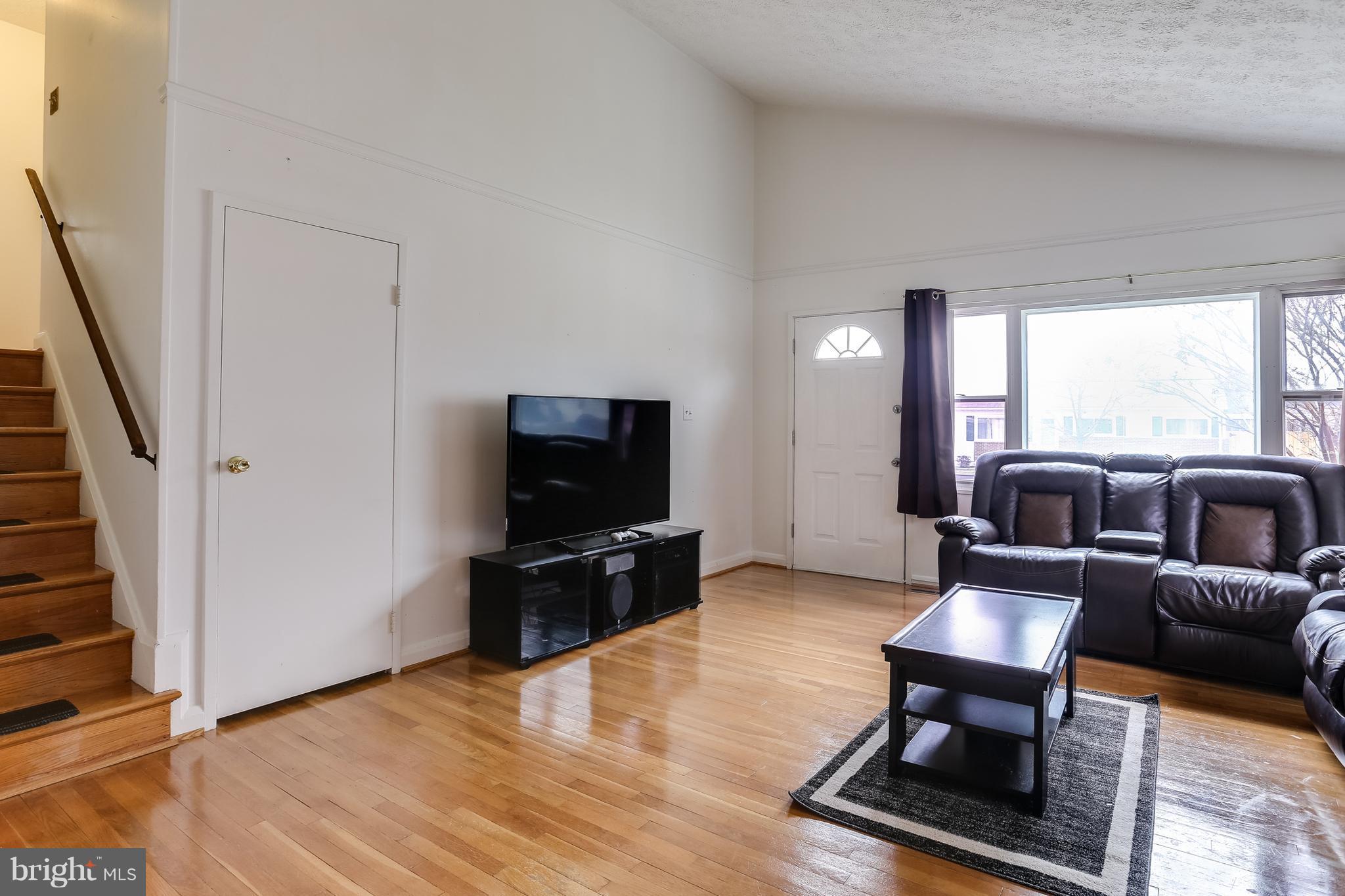 936 Vanderwood Road Baltimore, MD 21228 - Photo 5 of 27 a living room with furniture and a flat screen tv