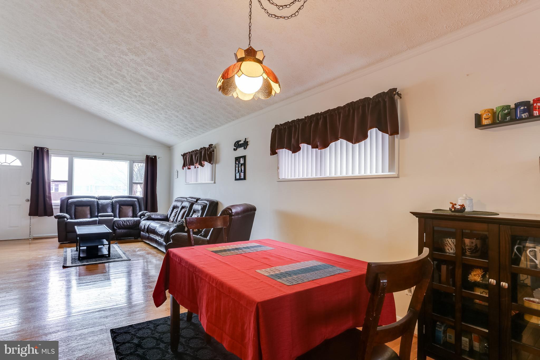 936 Vanderwood Road Baltimore, MD 21228 - Photo 7 of 27 a bedroom with a bed and wooden floor