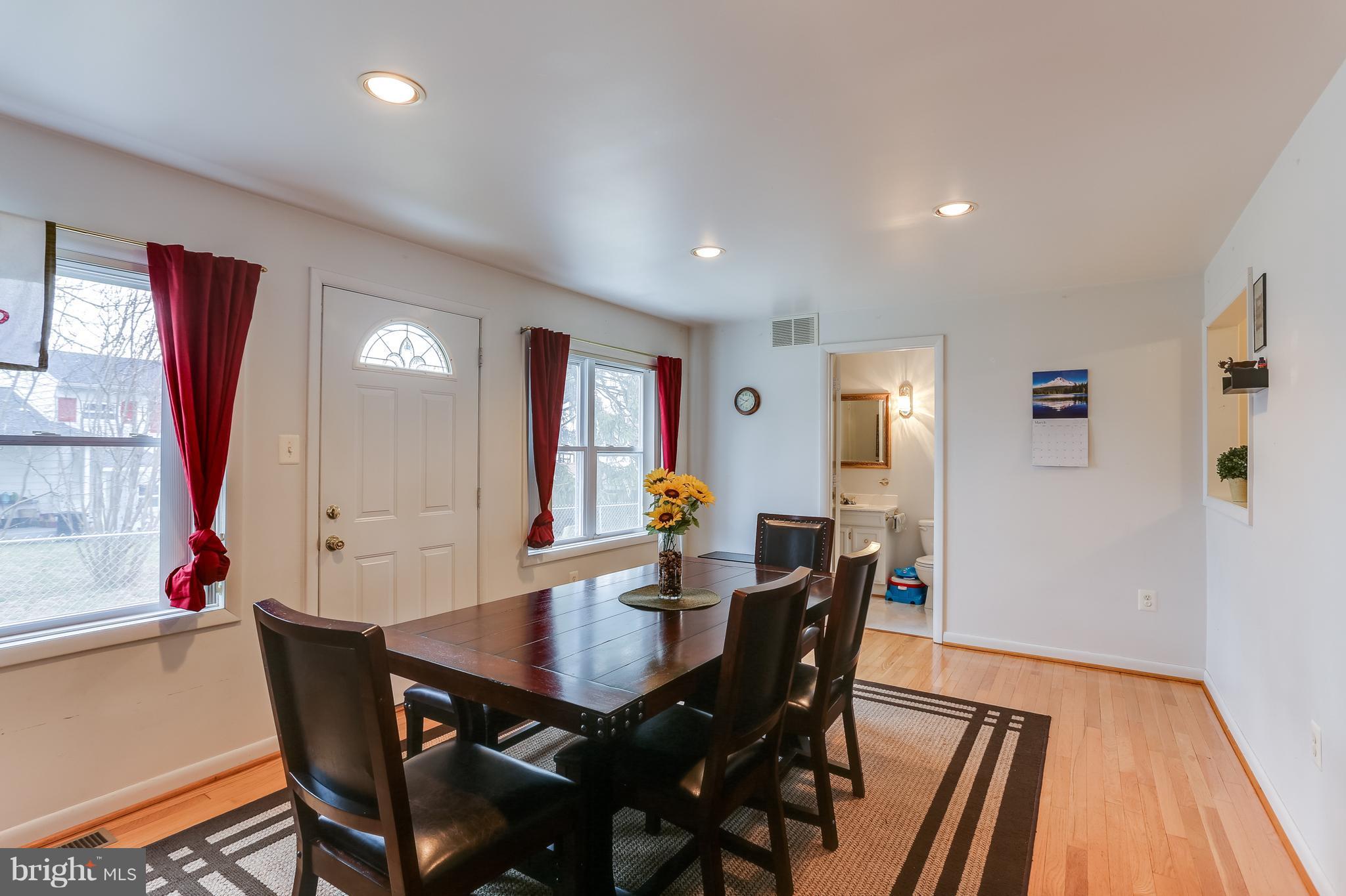 936 Vanderwood Road Baltimore, MD 21228 - Photo 8 of 27 a view of a dining room with furniture and wooden floor