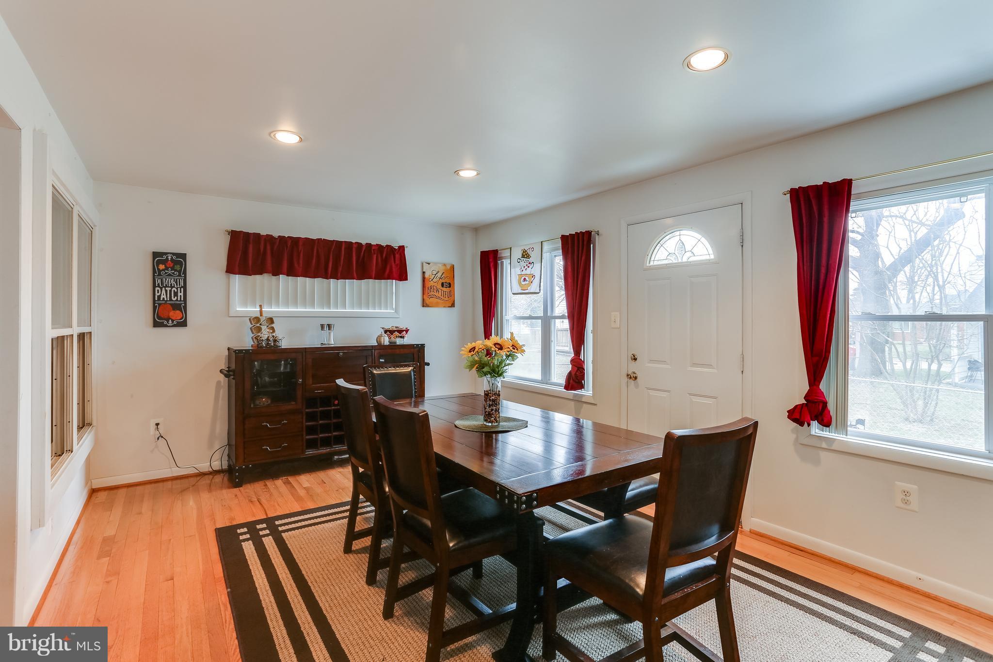 936 Vanderwood Road Baltimore, MD 21228 - Photo 9 of 27 a view of a dining room with furniture window and wooden floor