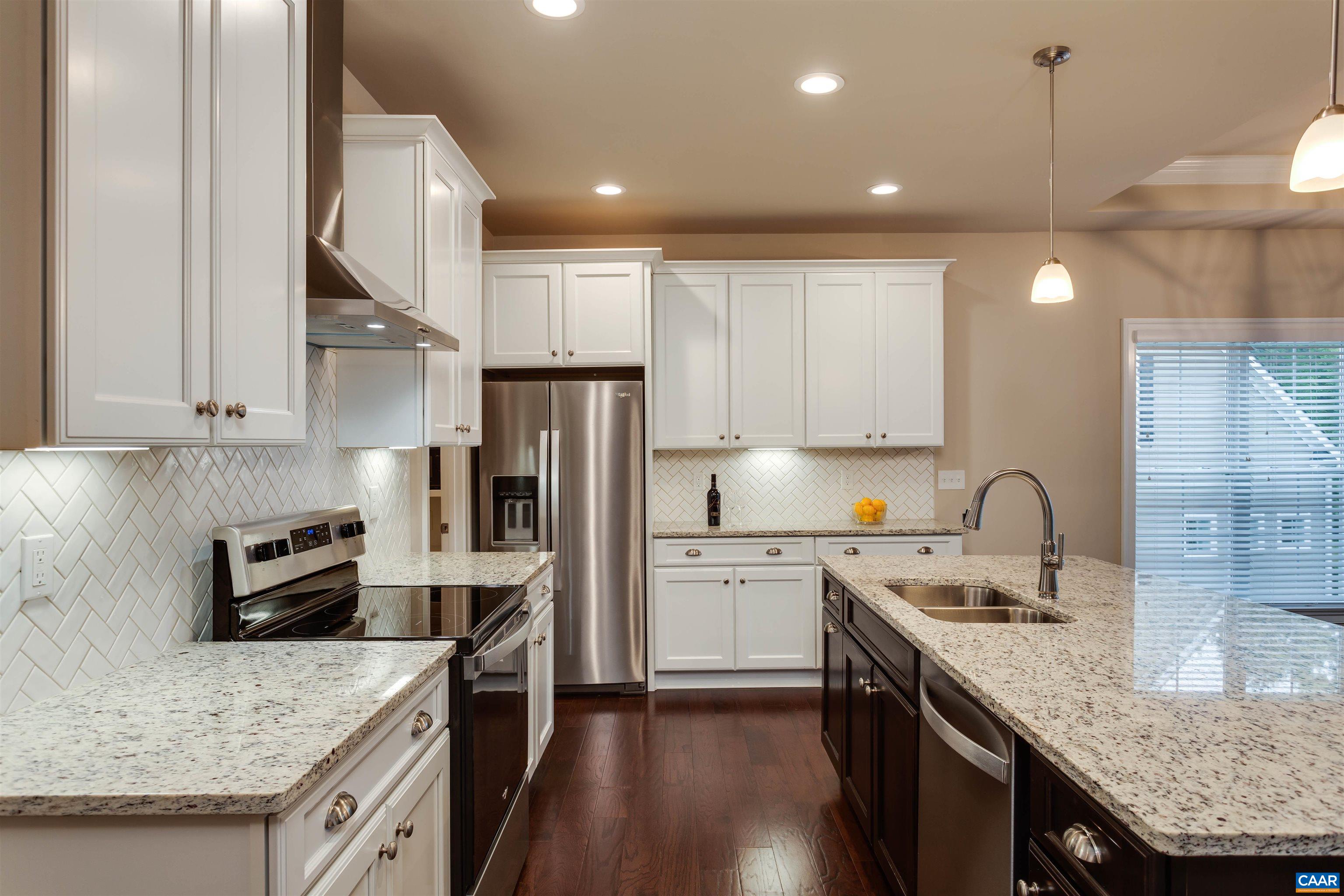 596 Drumin Road Keswick, VA 22947 - Photo 12 of 57 a kitchen with stainless steel appliances granite countertop a sink stove and refrigerator