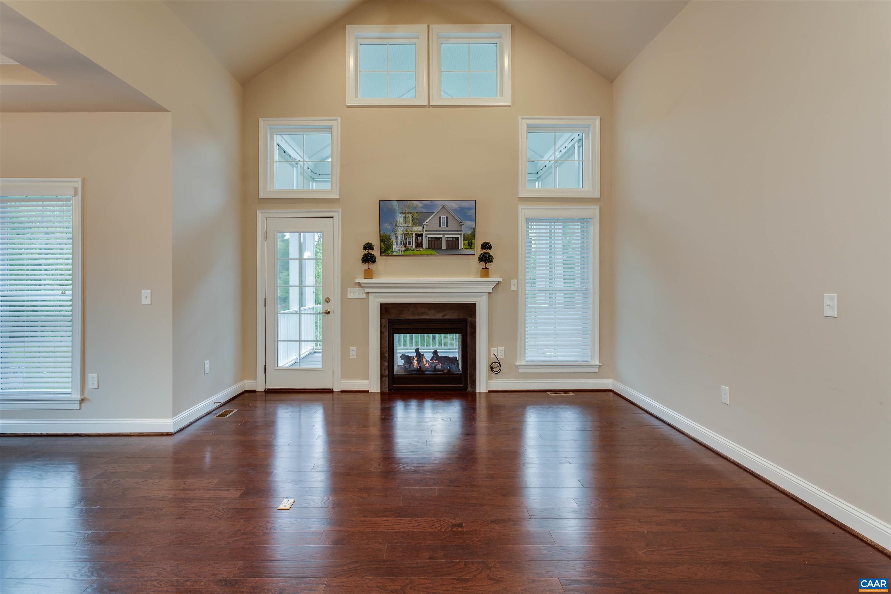596 Drumin Road Keswick, VA 22947 - Photo 16 of 57 a view of a livingroom with wooden floor and a fireplace