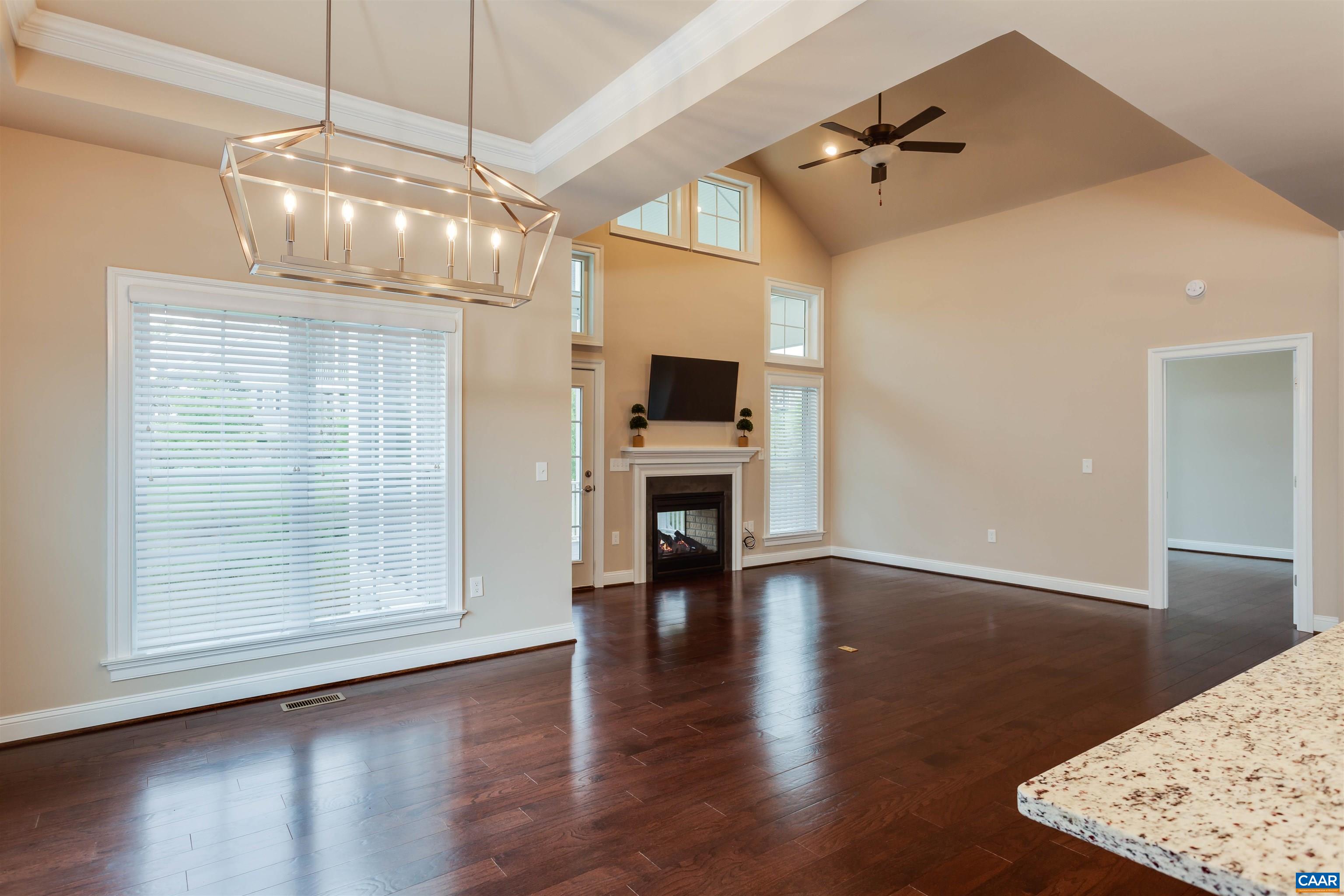 596 Drumin Road Keswick, VA 22947 - Photo 20 of 57 a view of an empty room with wooden floor fireplace and a window