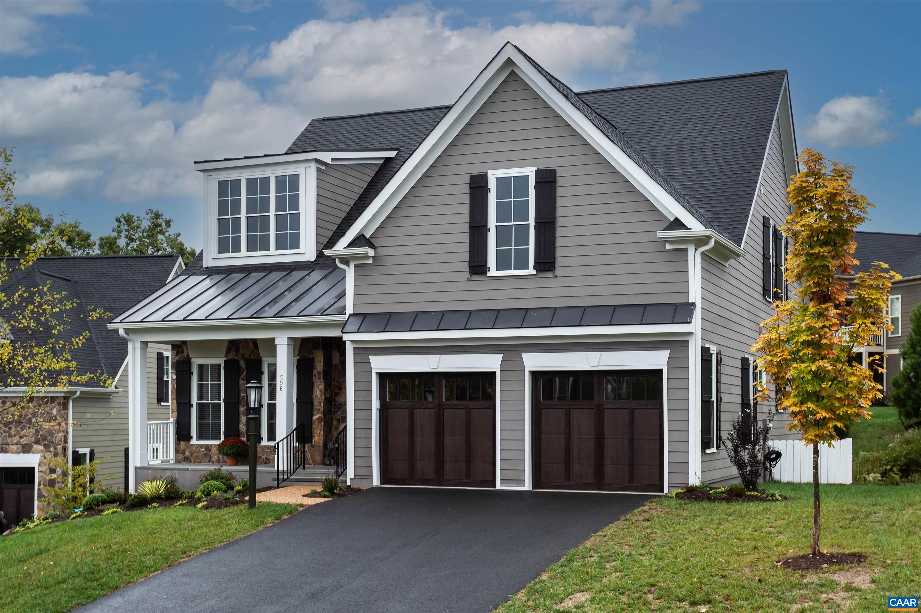 596 Drumin Road Keswick, VA 22947 - Photo 2 of 57 a front view of a house with a yard and garage